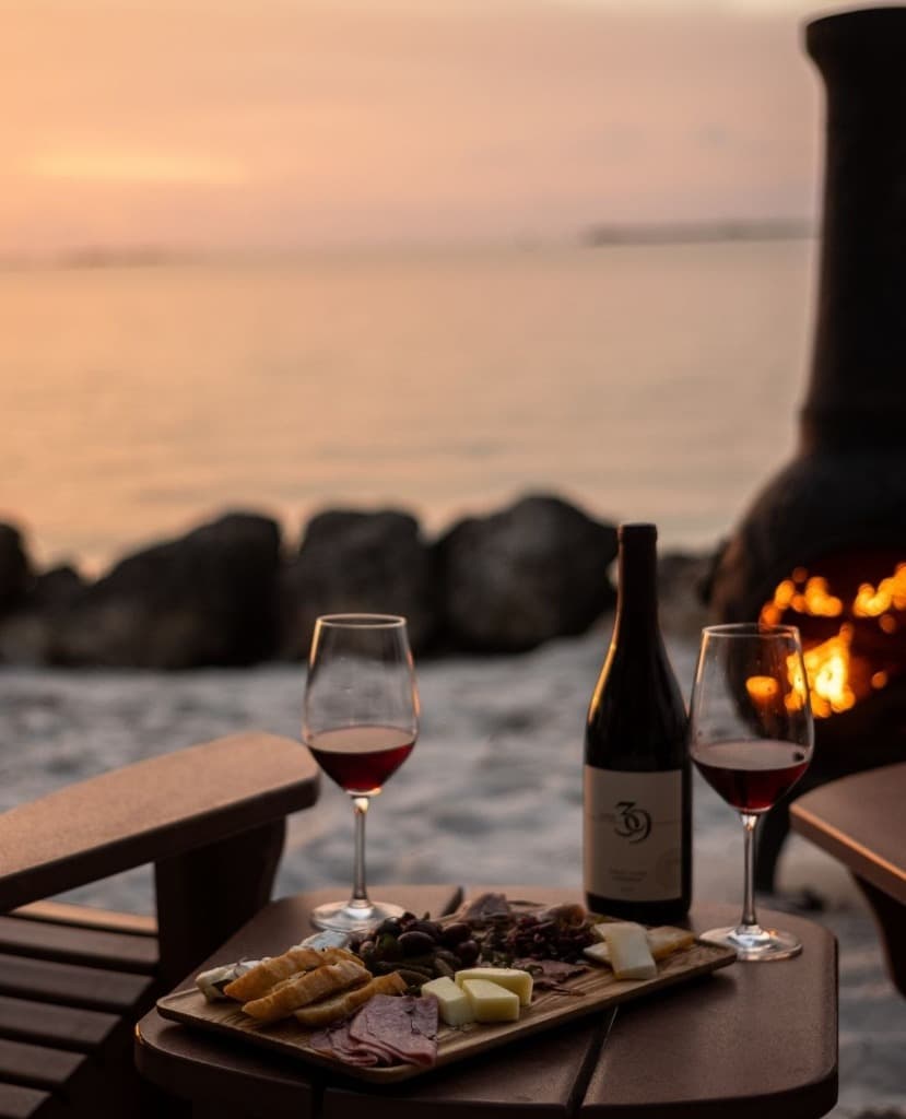 Charcuterie and wine by the firepit at sunset