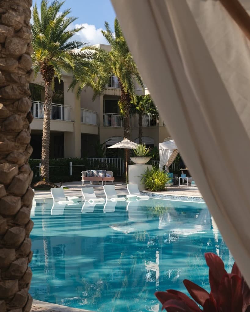 Pool with in-water loungers and cabanas