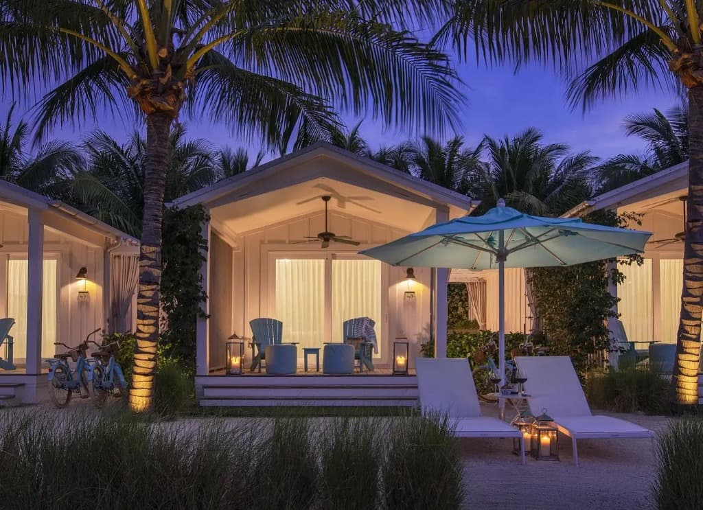 Beachside bungalow lit up at twilight