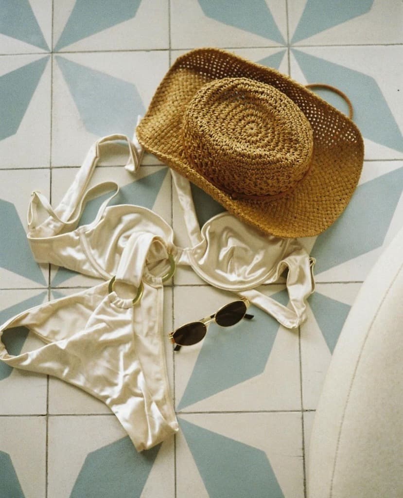 Swimwear and straw hat on geometric tiles