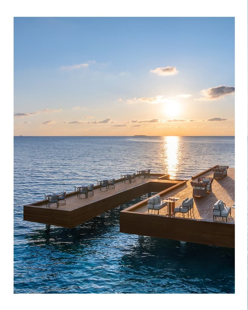 Overwater dining deck at golden hour